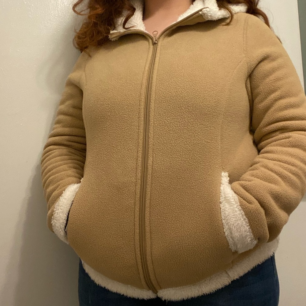 A beige fluffy coat.